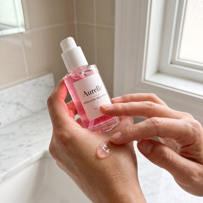 Aurelle PDRN Glow Jelly Serum applied in a bright bathroom