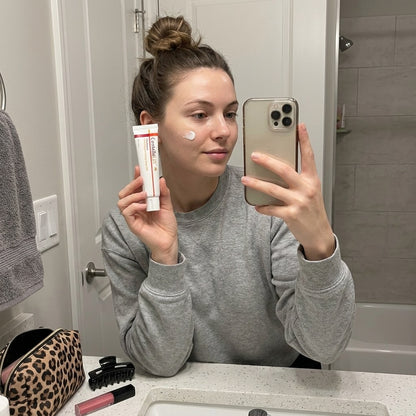 Woman using CentellaLift Repair Cream at home