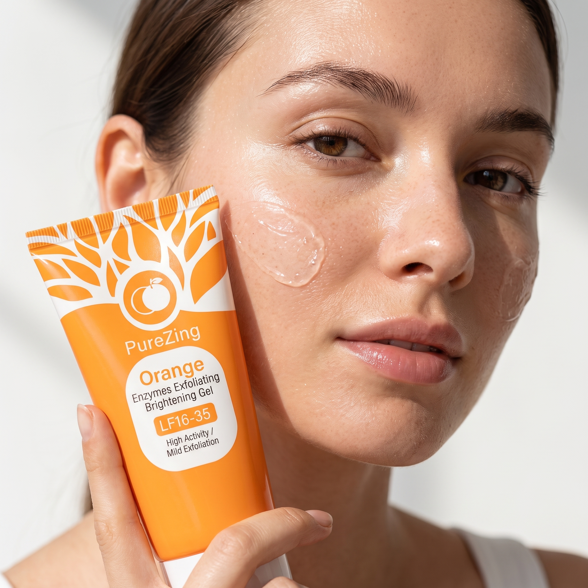 Close-up of woman applying PureZing exfoliating gel to her cheek with the tube in frame