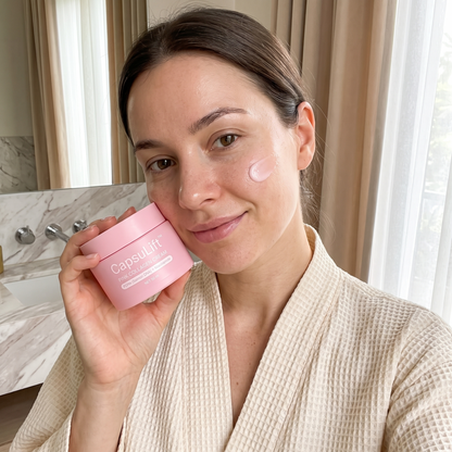 Woman applying CapsuLift Pink Collagen Cream