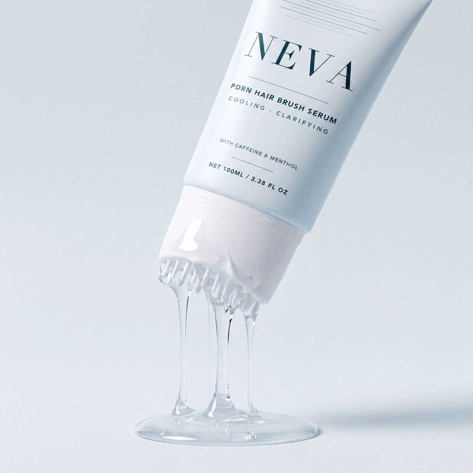 The NEVA tube being squeezed, clear serum flowing out between the applicator teeth