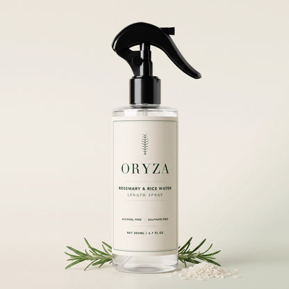 The ORYZA 200ml clear spray bottle with black trigger head, beside fresh rosemary and rice grains