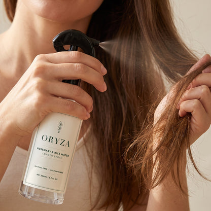 Close view of ORYZA being misted onto a gathered section of mid-lengths and ends