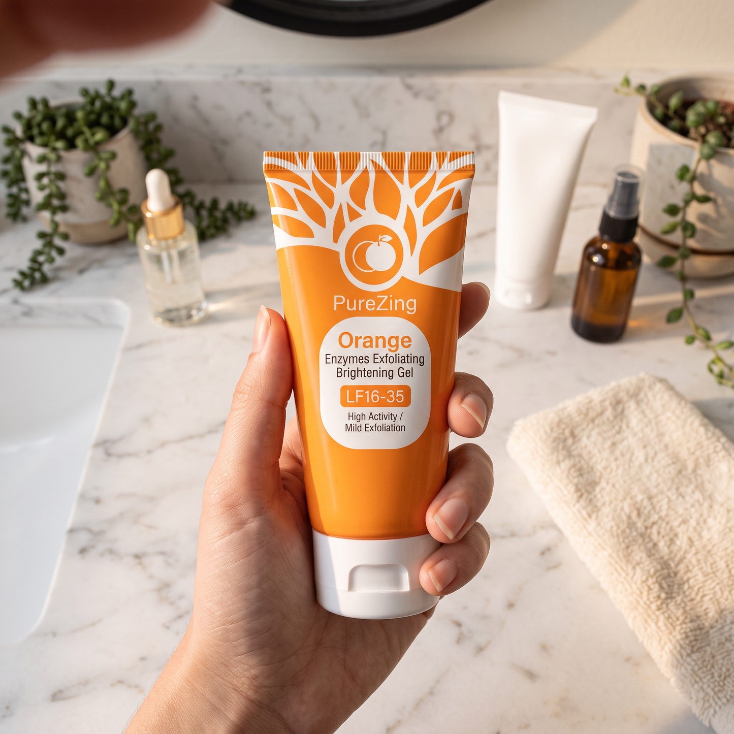 Holding PureZing Orange Exfoliating Gel on marble bathroom counter