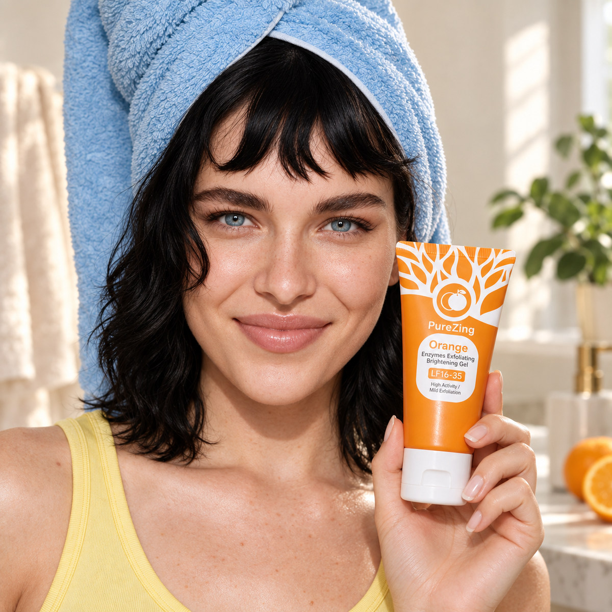 Woman wearing a blue towel turban holding an orange PureZing Skin Renew Gel tube