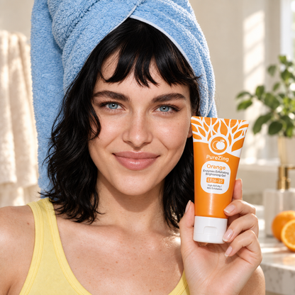 Woman wearing a blue towel turban holding an orange PureZing Skin Renew Gel tube