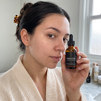 Woman holding RetinSilk Night Resurfacing Drops